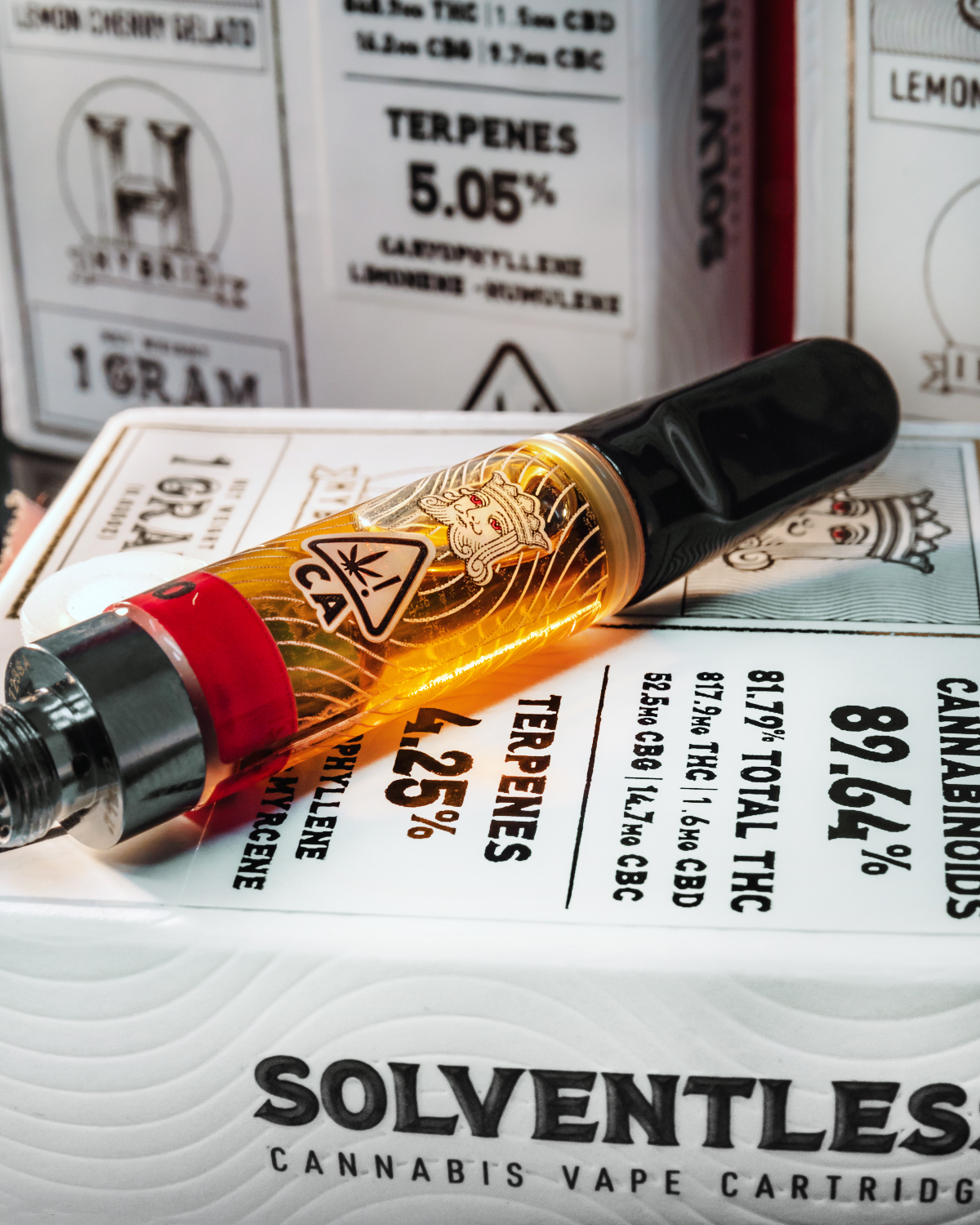 Kingpen Solventless vape cartridge on top of package showing golden oil and CA adult use warning label